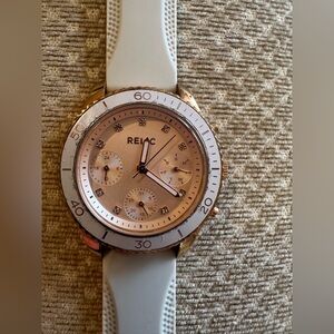 Relic watch for ladies. Cream Rubber band. Rose Gold tons. Running.
